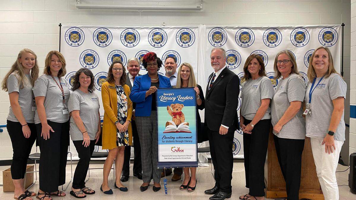 Georgia Department of Education superintendent Richard Woods presents New Mountain Hill Elementary School with its 2023 Literacy Leader award Sept. 12, 2023, in the school’s cafeteria. Pictured are Aron Milam, Kristie Graham, April Neal, Erin Miley, HCSD Superintendent Roger Couch, NMHE Assistant Principal Anita Wadley, HCSD K-6 Curriculum Director Dave Dennie, NMHE Principal Jessica Burnett, Georgia School Superintendent Richard Woods, Julie Edingfield, Cortni Madrigal and Sherry Pinet.
