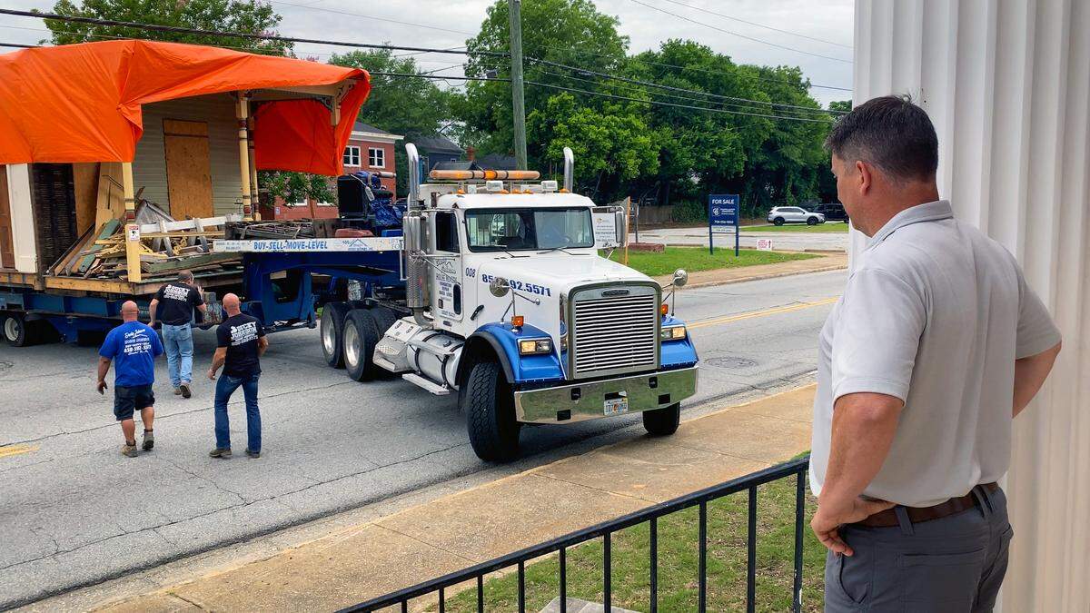 Justin Krieg, director of planning and programs for Historic Columbus, watches as the Alma Thomas House is moved May 12, 2026, from 411 21st St. in Rose Hill and placed next to the Ma Rainey Home, 805 Fifth Ave., in the Liberty Heritage Historic District.