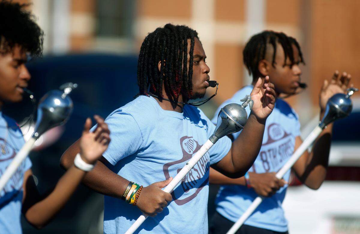 Marquis Alfred, center, is the head drum major for the G.W. Carver High School Mighty Marching Tigers from Columbus, Georgia. 12/29/2022