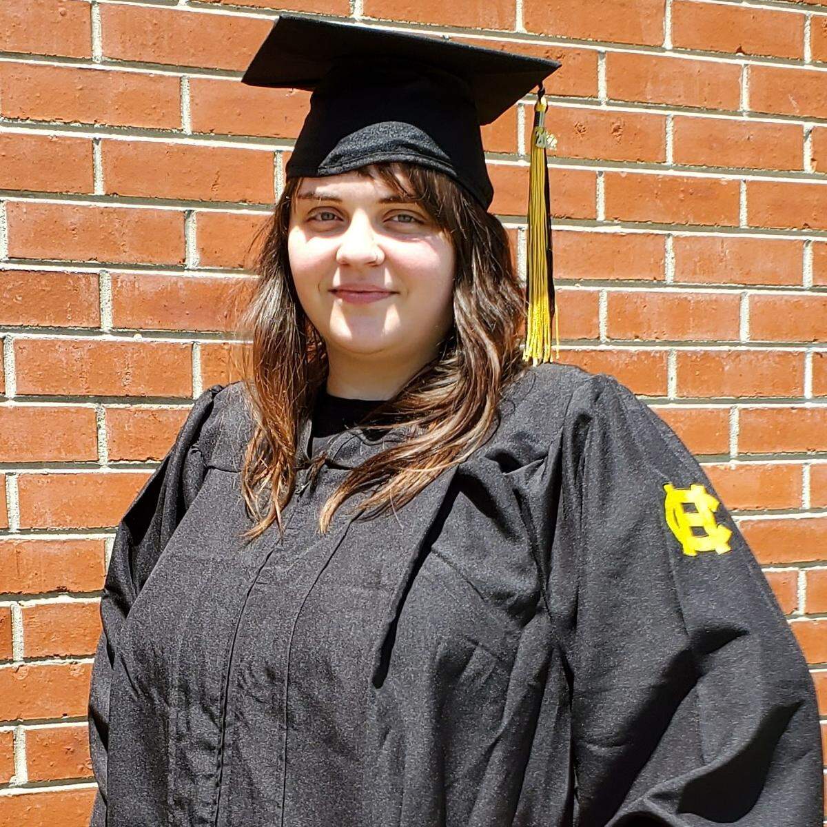 Kellie Finnegan poses in her graduation cap and gown.