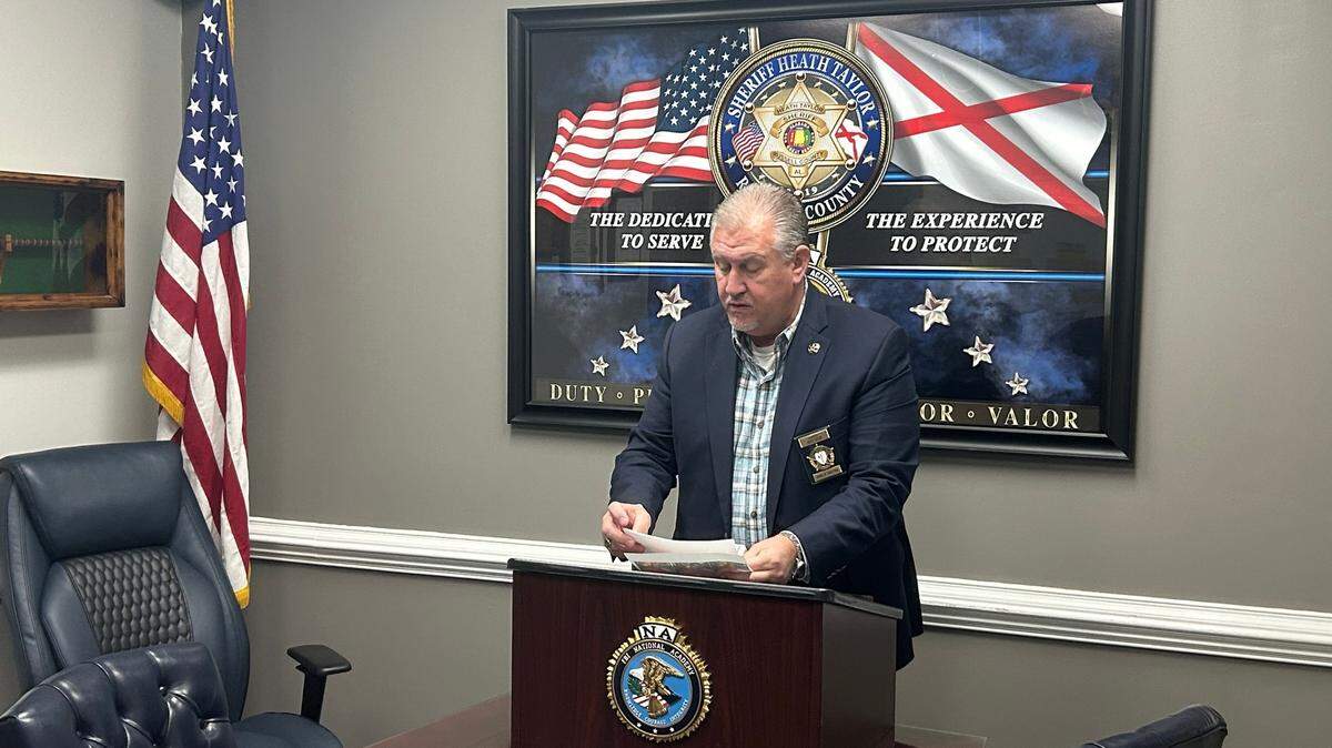Russell County Sheriff Heath Taylor stands behind a podium during a press conference regarding the death of Travis Upshaw. 1/26/2025