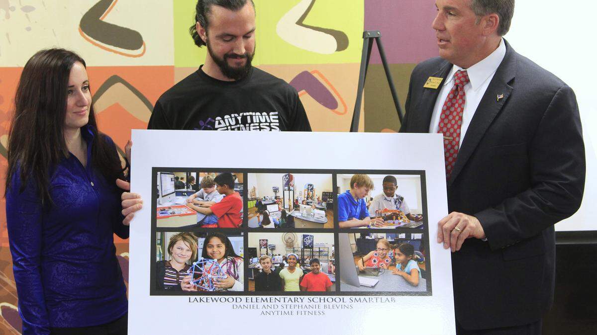 Mike Haskey mhaskey@ledger-enquirer.com 
 Randy Wilkes, superintendent of Phenix City Public Schools, right, thanks Daniel and Stephanie Blevins, owners of the Anytime Fitness in Phenix City, for the $25,000 donation they announced Thursday to help pay for a $120,000 SmartLab at Lakewood Elementary School. 01/14/16