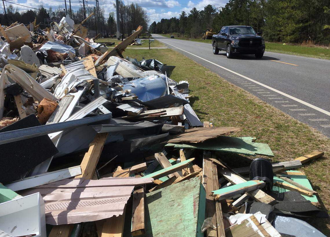 Large piles of storm debris from the recent tornadoes are staged along Alabama Highway 51 in Beauregard, Alabama awaiting removal. The community of Beauregard, Alabama is in the very early stage of recovering from the devastating tornadoes that ripped through the area March 3, killing 23 people and causing devastating damage to homes and property across Lee County.