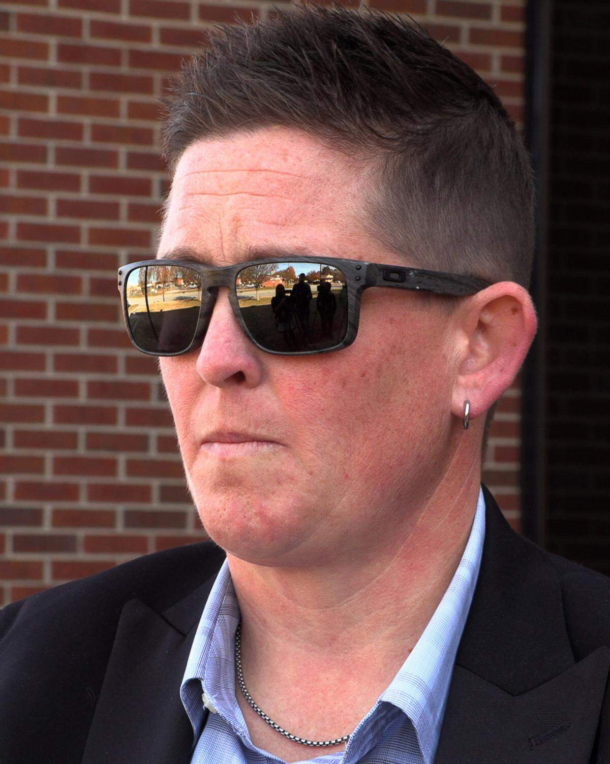 Sgt. Jane Edenfield speaks with reporters after a 2023 fraud hearing.