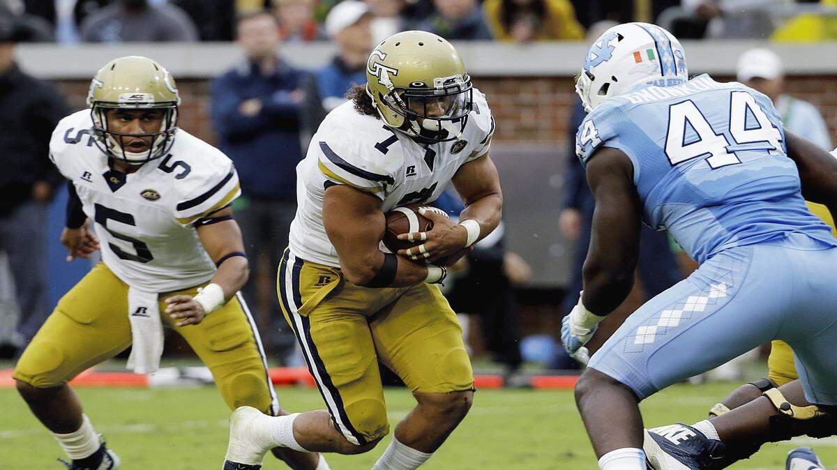 DAVID GOLDMAN/Associated PressGeorgia Tech's Patrick Skov, center, runs the ball on a handoff from quarterback Justin Thomas, left, as North Carolina's Junior Gnonkonde, right, defends in the third quarter Oct. 3 in Atlanta. North Carolina won 38-31.