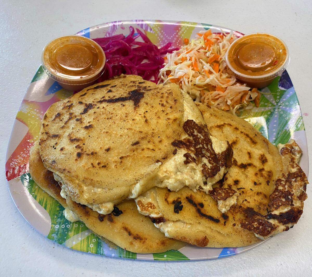 Ledger-Enquirer reporter Kelby Hutchison and visual journalist Mike Haskey split this dish, which included four pupusas, two sides and sauce, during a Sept. 10, 2025, lunch trip to Pupuseria Mi Redentor, 4125 Hamilton Road in Columbus.