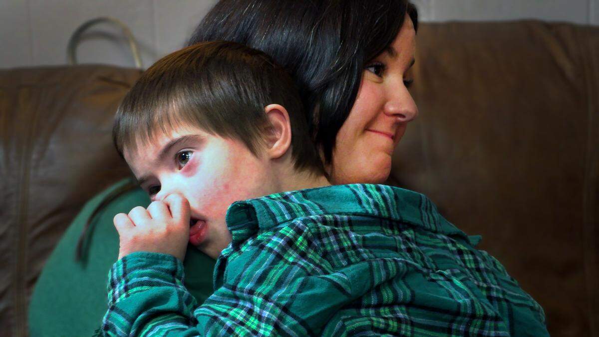 Carrie Defenbaugh holds her son Grayson during a Dec. 23, 2024, interview with the Ledger-Enquirer.