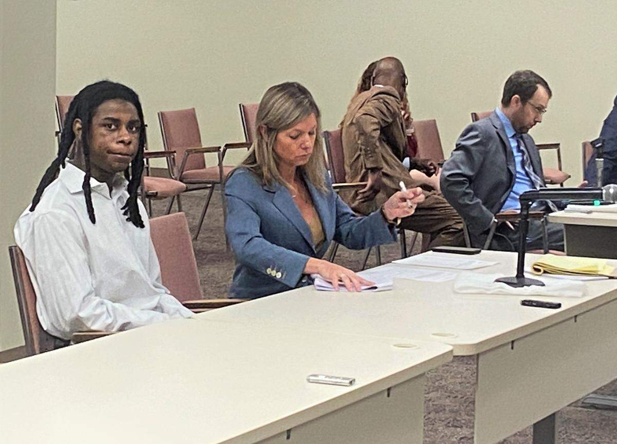 Ceuion Marque English awaits his guilty plea Monday as defense attorney Jennifer Curry fills out his paperwork.