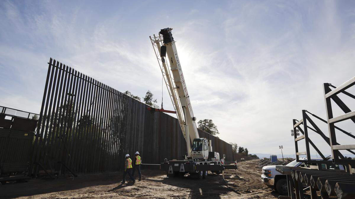 Construction continues on a new, taller version of the border structure in Calexico, Calif., in this 2018 file photo.