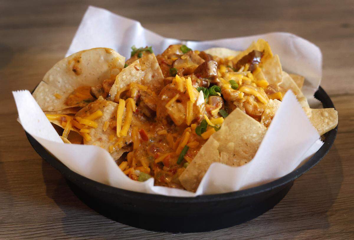 The Cajun Nachos at Hank’s Bar & Grill, 1037 Broadway in Columbus, features tortilla chips topped with Hank’s signature Cajun Dip, bacon, cheese and green onions, pictured Oct. 21, 2025.