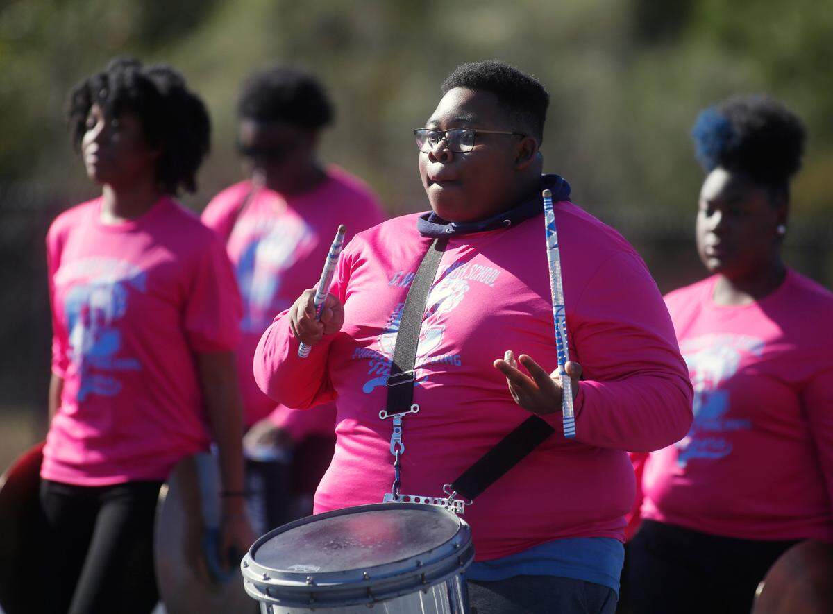 Brandon Boden, center, band captain and percussion caption with the G.W. Carver High School Mighty Marching Tigers from Columbus, Georgia rehearses with other band members Thursday afternoon for their participation in the upcoming Peach Bowl Parade in Atlanta, Georgia. 12/29/2022