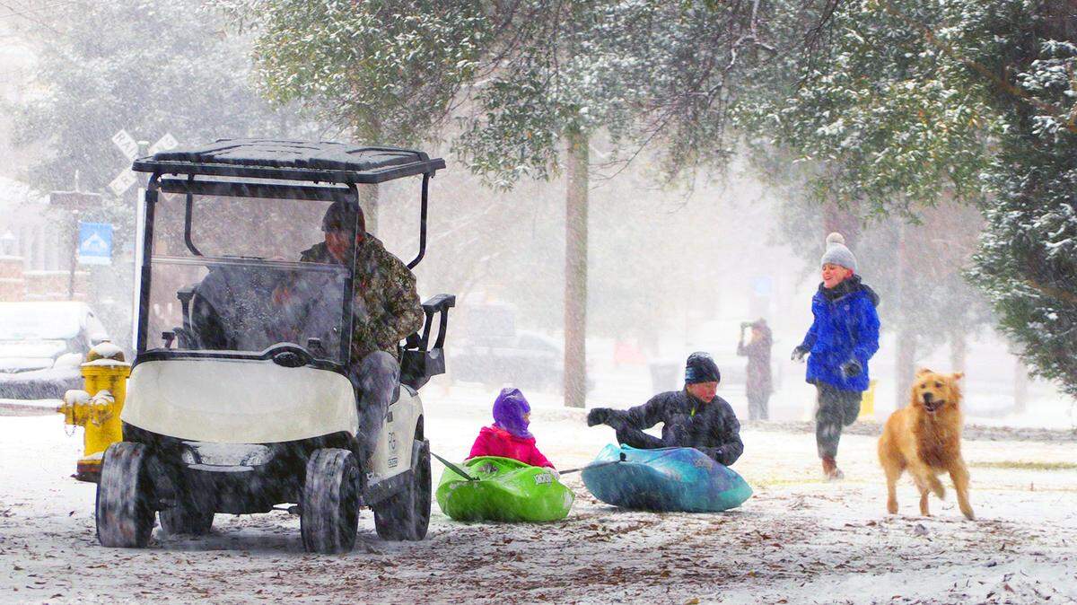 Falling and accumulating snow in Columbus, Georgia gave residents plenty of chances to find creative ways to have fun, inluding some who used kayaks as impromptu sleds in a median of Broadway in Columbus’ Historic District on January 21, 2025.