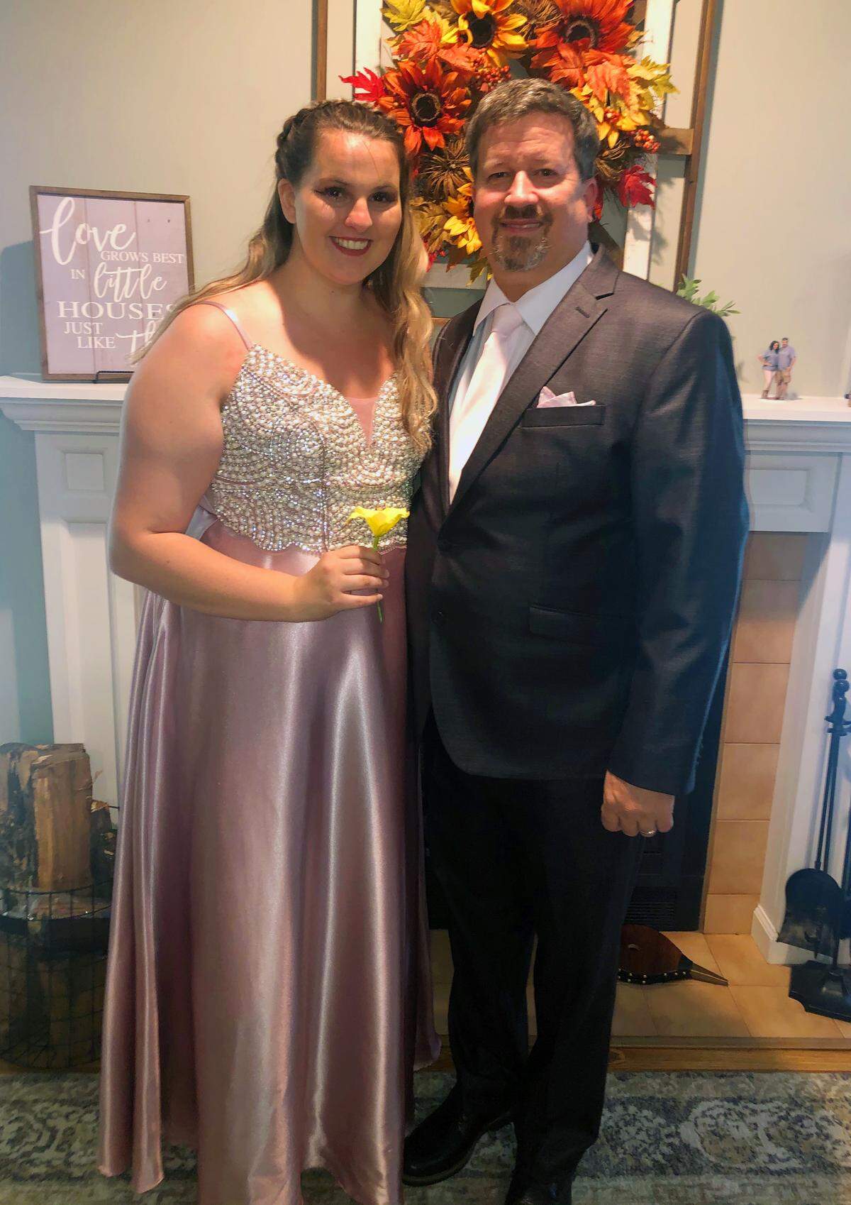 Reagan Thomas, a senior at Harris County High School in Hamilton, Georgia, and her stepfather Jeff Yancey pose for a photo recently after Reagan’s family threw her a “surprise prom.”