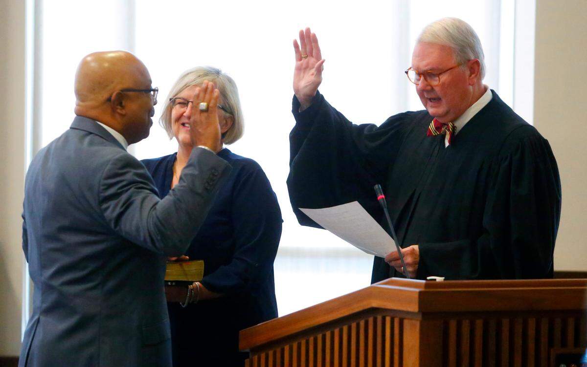 Superior Court Judge Art Smith III, right, swears in Byron Hickey, left, Tuesday morning during the Columbus Council meeting. 07/09/2024