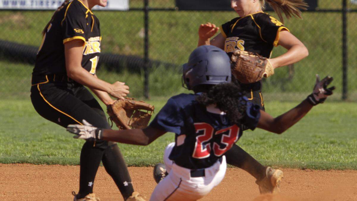 ROBIN TRIMARCHI/rtrimarchi@ledger-enquirer.comHarris County High shortstop Abbey Thomason, left, covers the base as second baseman Abby White, right, tags the base for the out Northside runner Kennedi Bedell Thursday at the Northside ballfield.