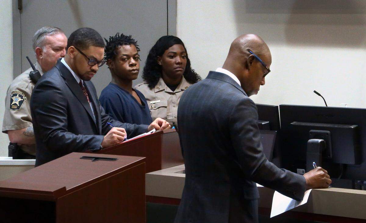 District Attorney Stacey Jackson, right, and public defender Payton Vernon, second from left, take notes from the testimony of Sgt. Donna Baker of the Columbus Police Department Monday morning during a hearing in Columbus Recorder’s Court for Jerimiah Walker, center. 05/01/2023