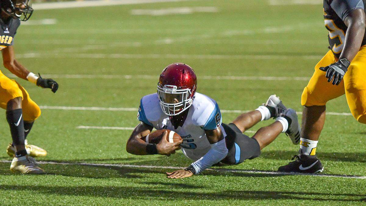 Carver’s Devin Riles dives into the endzone for a touchdown in the first quarter of the game against Harris County Friday night, August 23, 2019.
