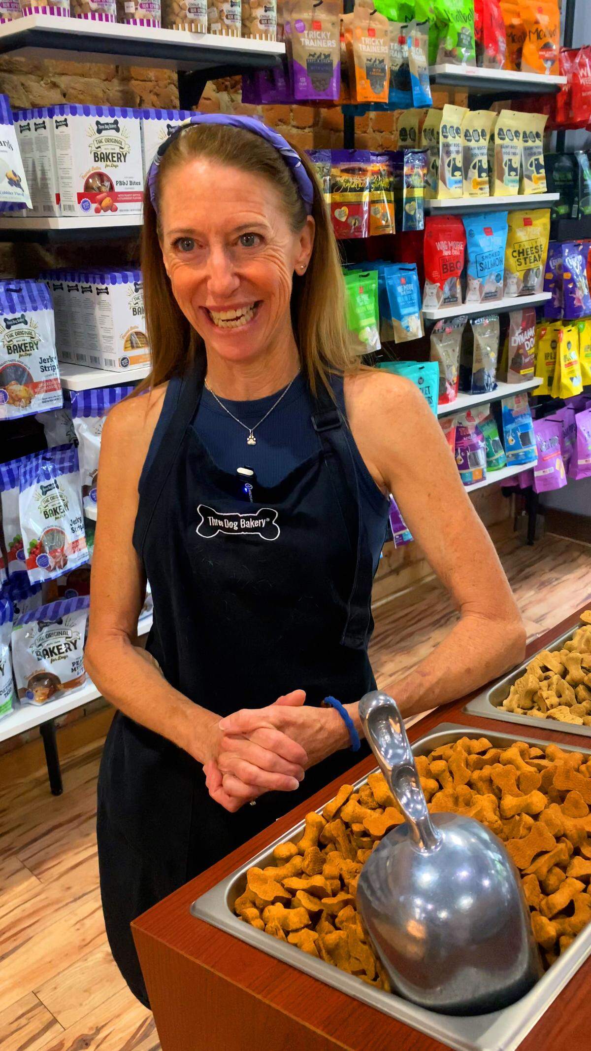 Tracy St. John, franchise owner of the Three Dog Bakery in Columbus, answers questions about the variety of specialty dog treats they offer. She and her husband, Joey, opened the store in 2024. 05/29/2025