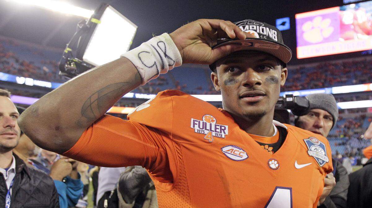 FILE - In this Dec. 6, 2015, file photo, Clemson quarterback Deshaun Watson celebrates after Clemson defeated North Carolina 45-37 in the Atlantic Coast Conference championship NCAA college football game in Charlotte, N.C. Deshaun Watson is the Atlantic Coast Conferenceís offensive player of the year and one of four Tigers on The Associated Press All-ACC first team. (AP Photo/Gerry Broome, File)