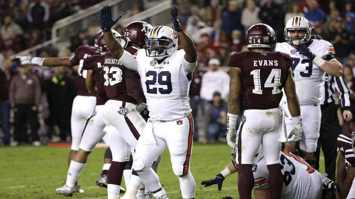 Auburn running back Jovon Robinson (29) raises his arms after rushing for a touchdown against Texas A&M during the second quarter of an NCAA college football game, Saturday, Nov. 7, 2015, in College Station, Texas. (AP Photo/David J. Phillip)