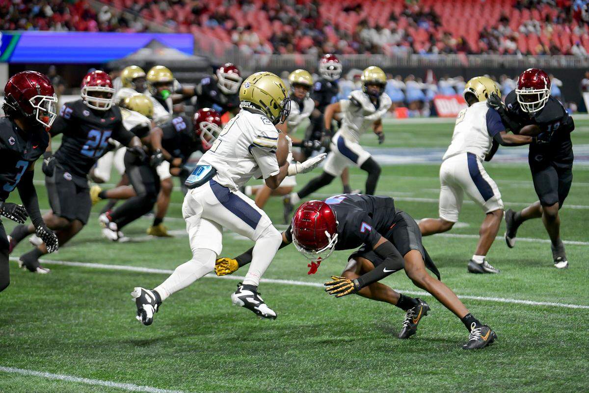 Carver senior defensive back Travis Murphy makes a tackle against Hapeville Charter during the Georgia High School Association Class 2A football state championship game Dec. 16, 2025, at Mercedes-Benz Stadium in Atlanta.