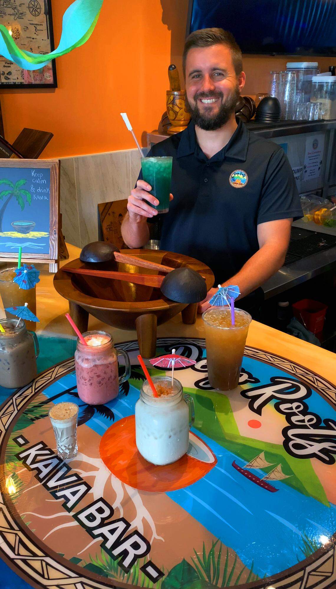 Dylan Heidrich, co-owner of Deep Roots Kava Bar, 2505 Airport Thruway, Suite K, in Columbus, talks Aug. 8, 2025, about the types of kava they serve and the variety of drinks they offer.