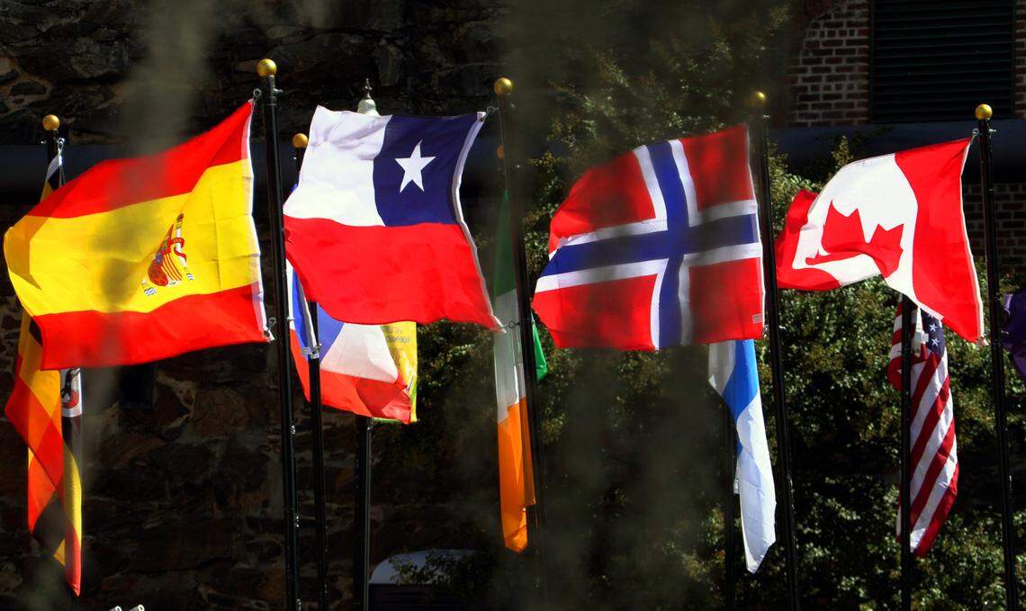 Flags representing the competitors in the 2023 ICF Canoe Freestyle World Championships line the bridge to Waveshaper Island. 10/05/2023