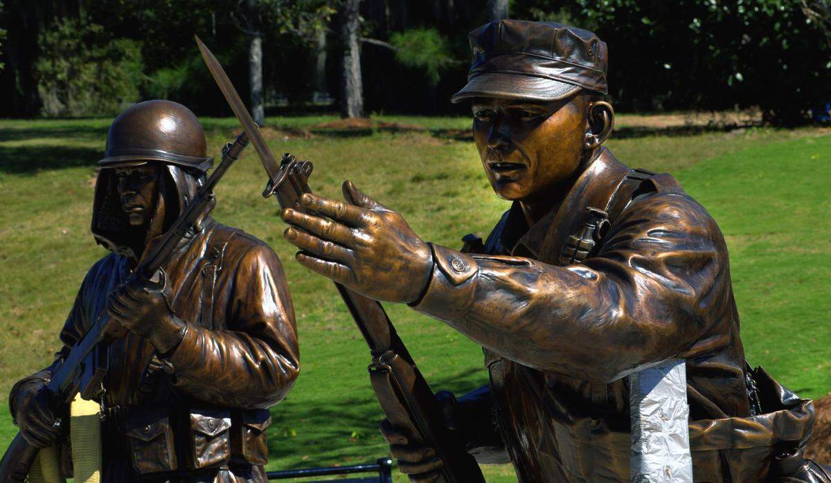 Four larger-than-life statues created by sculptor Jay Warren, including one of a U.S. Army Infantryman from the Korean War, left, and Col. Ralph Puckett (then a first lieutenant), right, have now been installed to the Korean War Memorial at the National Infantry Museum. 10/21/2024