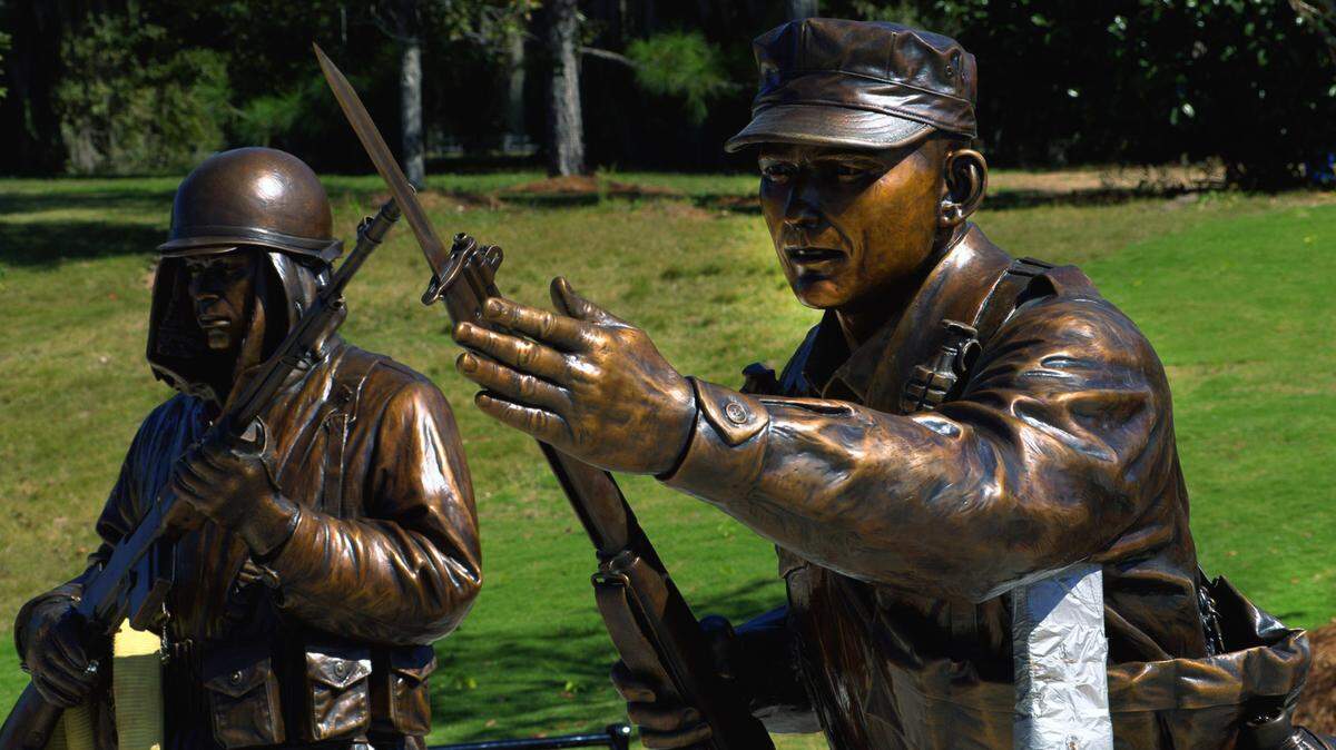 Four larger-than-life statues created by sculptor Jay Warren, including one of a U.S. Army Infantryman from the Korean War, left, and Col. Ralph Puckett (then a first lieutenant), right, have now been installed to the Korean War Memorial at the National Infantry Museum. 10/21/2024
