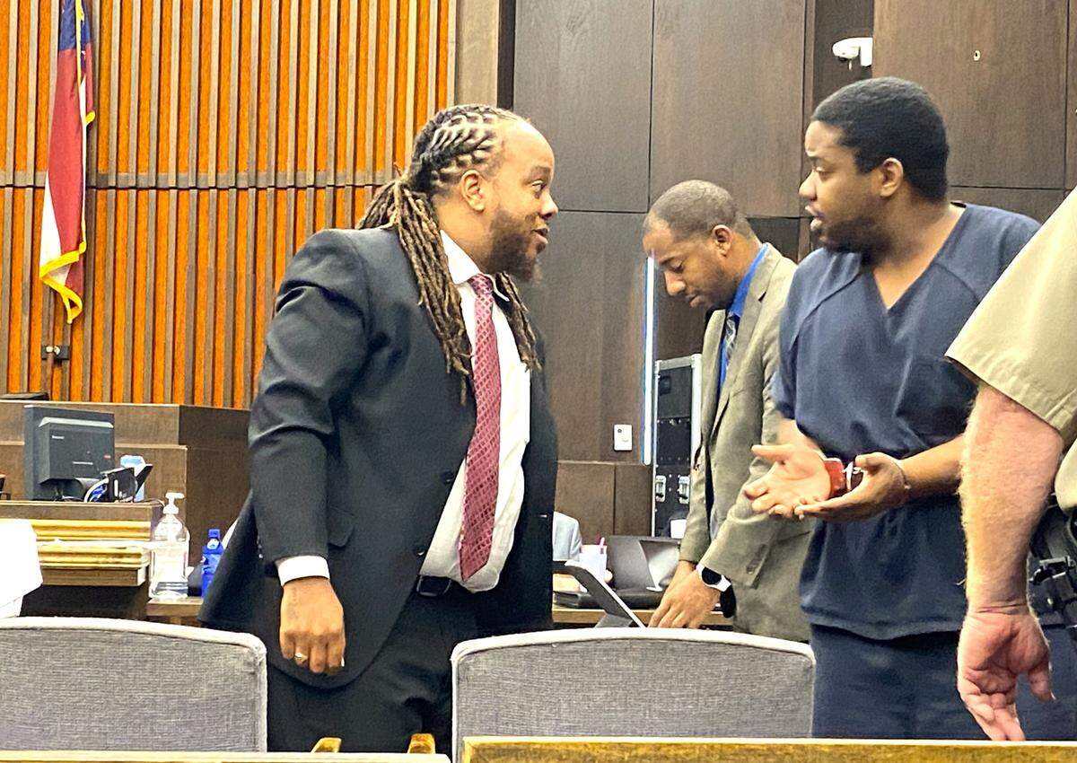 Attorney Shevon Thomas II, left, speaks with client Terrance Upshaw, who faces trial for murder in the death of two Columbus teenagers.