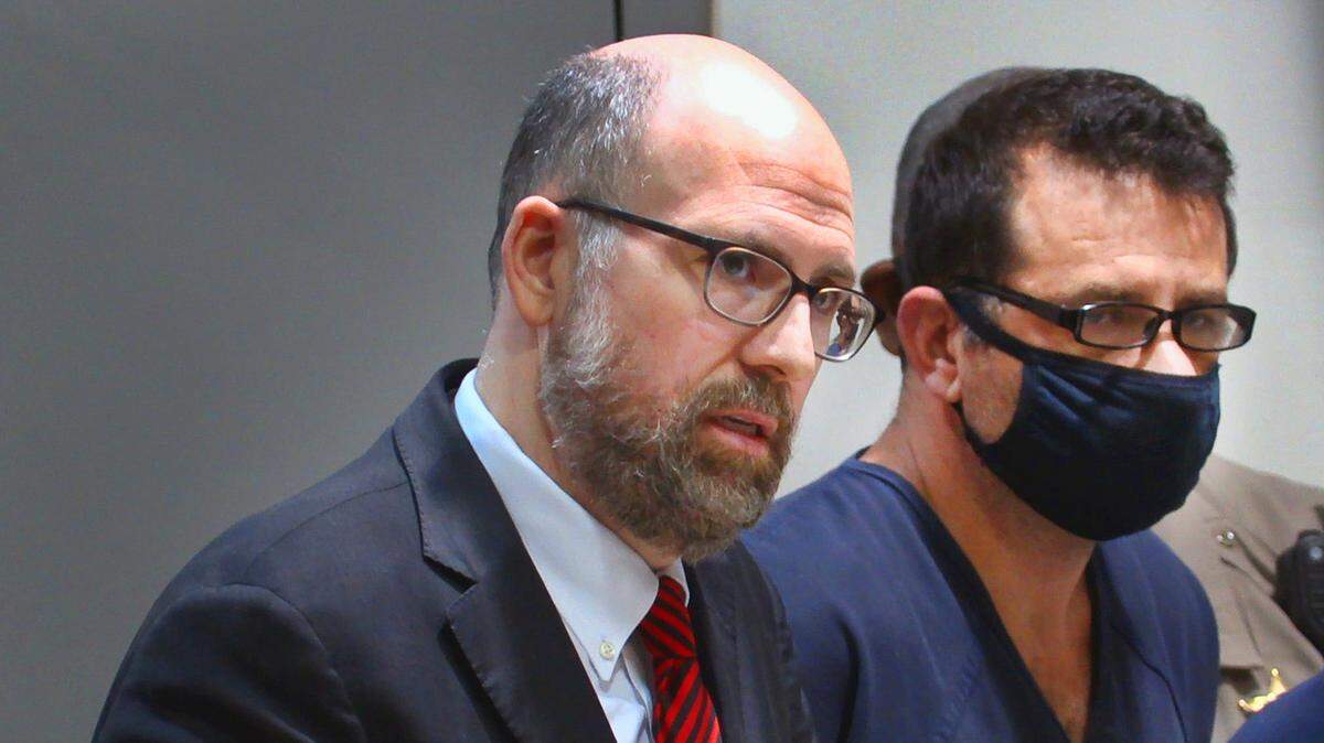 Attorney Robert Wadkins Jr. left, represents Carlos Alexander Rozwadowski, 46, right, during preliminary hearing in Columbus Recorder’s Court Feb. 28, 2022.