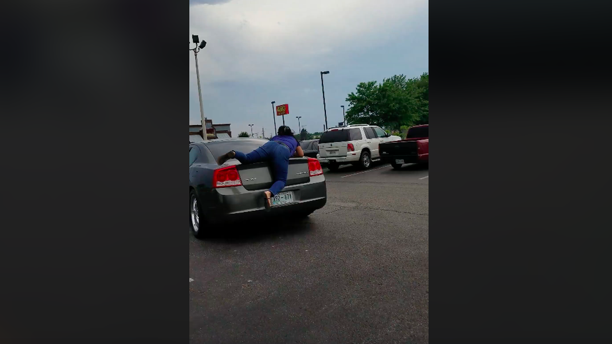 A Jackson, Tenn. woman faces a reckless endangerment charge after video caught her driving away as a nail salon employee clung to the back of her trunk. Police say the woman in the car did not pay for services rendered at the salon and the employee tried to stop her.