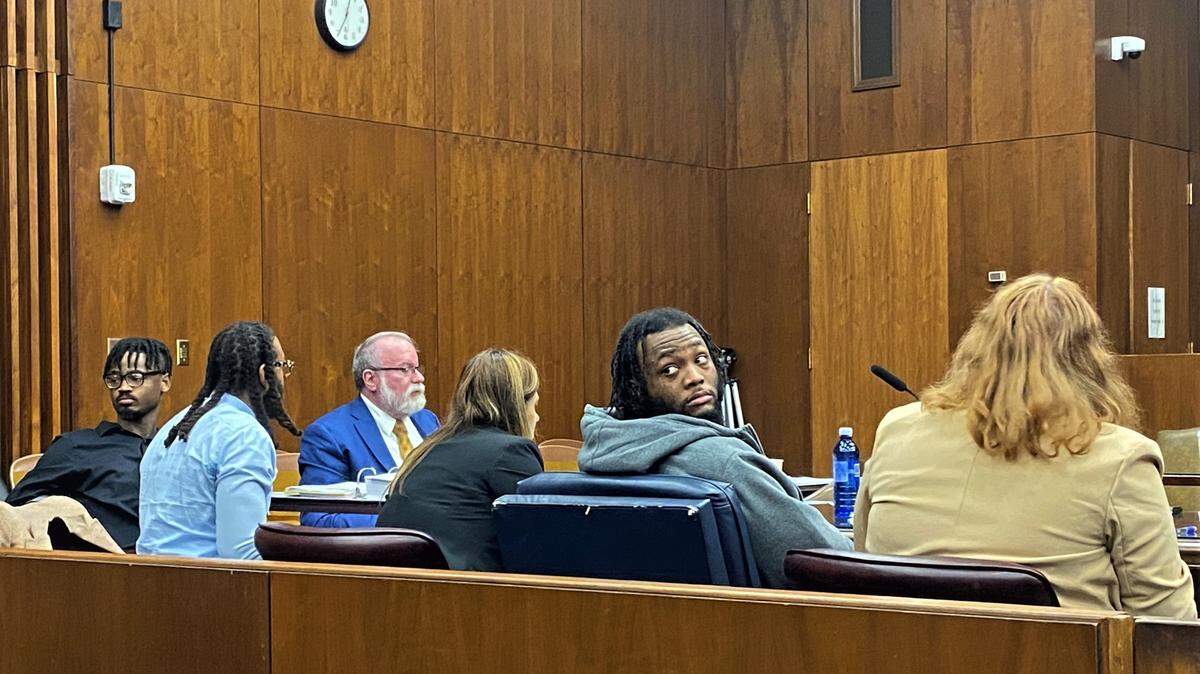 Ty’Shaun Sylvester, left, and Jessie Lee Harper, second from right, wait to leave the courtroom after closing arguments in the murder case against them.
