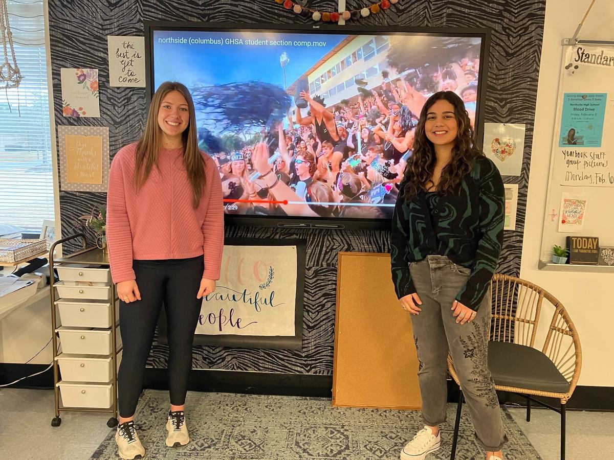 Northside High School seniors Kannon Wells, left, and Huda Sayedzada explain Feb. 14, 2023, are among the students in Libby Clay’s marketing class who produced the video that won the Georgia High School Association Class A-5A Student Section Spirit Challenge.