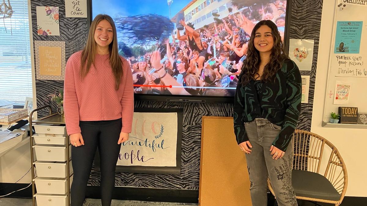 Northside High School seniors Kannon Wells, left, and Huda Sayedzada explain Feb. 14, 2023, are among the students in Libby Clay’s marketing class who produced the video that won the Georgia High School Association Class A-5A Student Section Spirit Challenge.