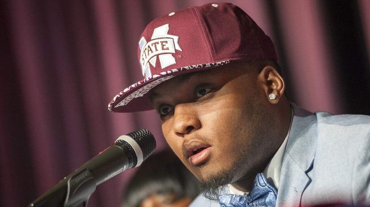 In this Feb. 5, 2015, file photo, Brookhaven High School football player Leo Lewis announces his decision to attend Mississippi State during a signing day event at the school in Brookhaven, Miss. Mississippi State players Lewis and Kobe Jones have, according to court documents, told the NCAA they received free merchandise from a clothing store while on recruiting trips to Ole Miss, something that would violate NCAA rules. They did so after being granted limited immunity by the NCAA, which protects them from being declared ineligible for wrongdoing as long as they told the truth.