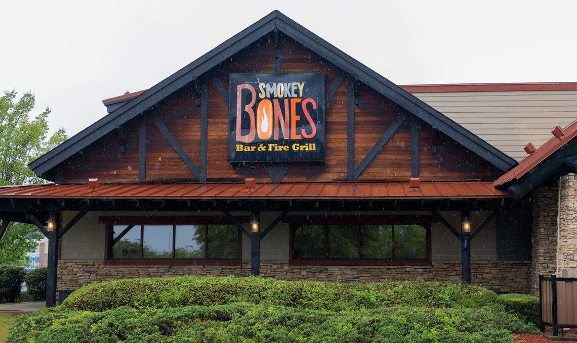 A sign on the door of the Smokey Bones in Columbus says the restaurant has permanently closed as of April 28, 2026.