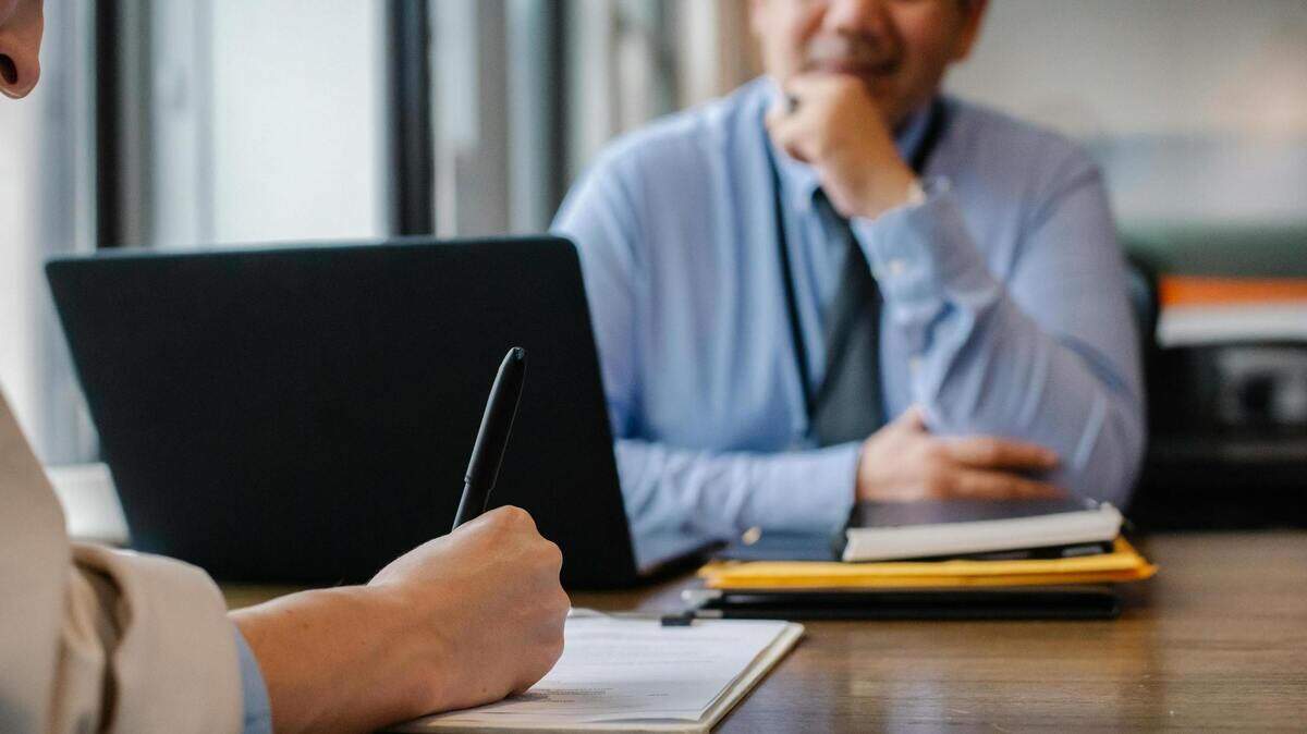 https://www.pexels.com/photo/woman-filling-job-application-form-in-office-with-boss-5668858/