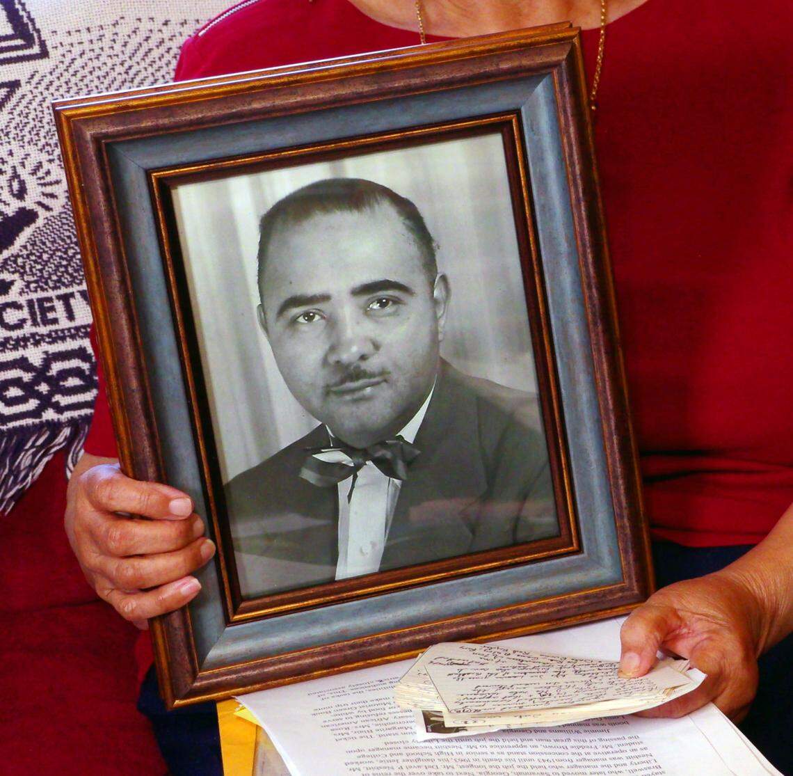 Jettie Nesbitt Lights holds a photograph of her father, D.P. Nesbitt. He was a manager of the theater in Columbus.