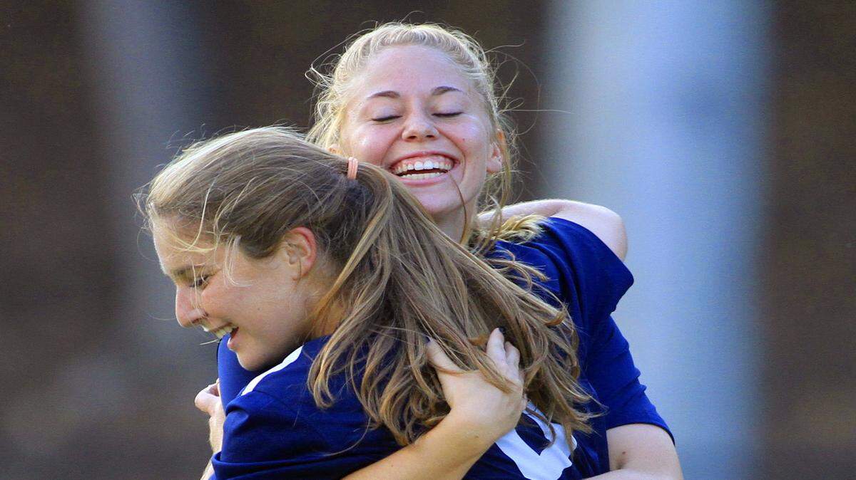 Columbus State's Stephanie Kolwicz, facing camera, hugs teammate Claire Belay after Belay scored a goal near the end of the first half against Lander University to put the Cougars up 3-2.