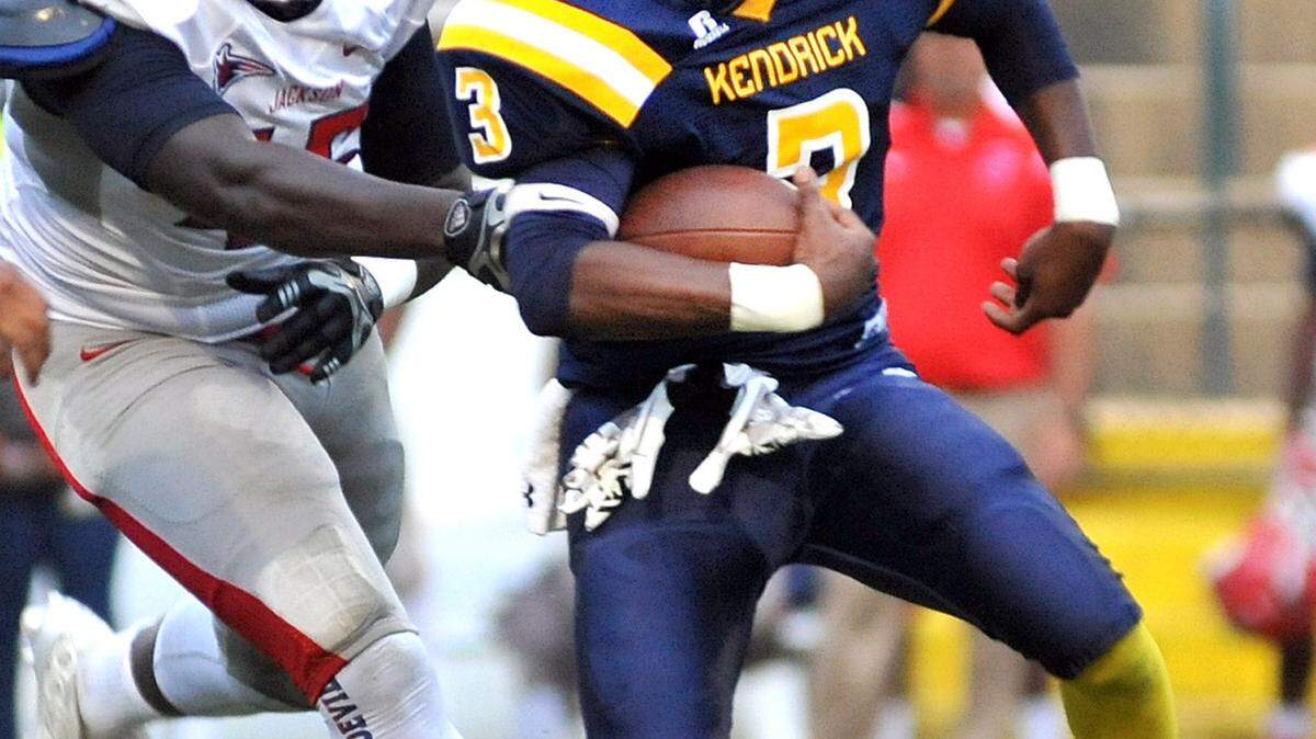 Kendrick's Nathan Mckissic trying to run past the tackle attempt of Jackson's Jaquaviuos Collins early in the 1st quarter of the game Friday night at Memorial Stadium