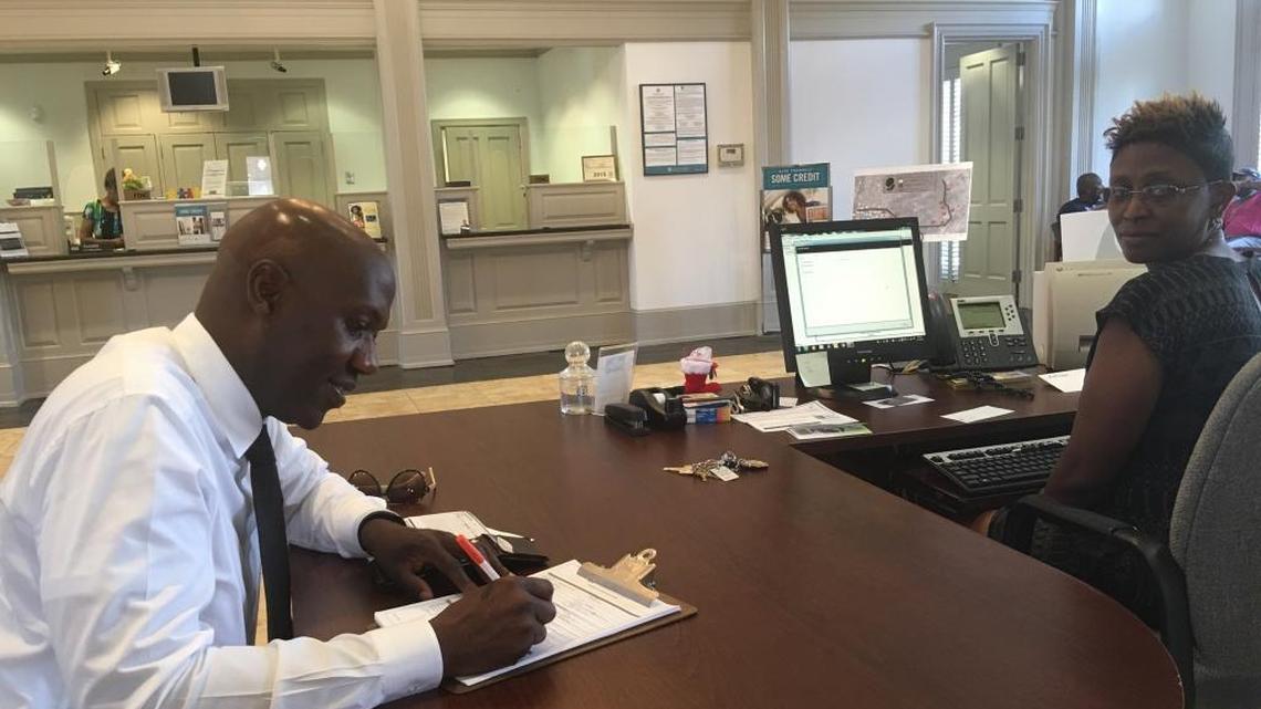 Micheal Muhammad, a member of the local organizing committee of the Justice or Else! Millions More March, opened a checking account at Citizens Trust Bank in the Midtown Shopping Center last month during “Black Dollars Day,” with the help of the bank’s Client Relationship Manager Tasha Toney.