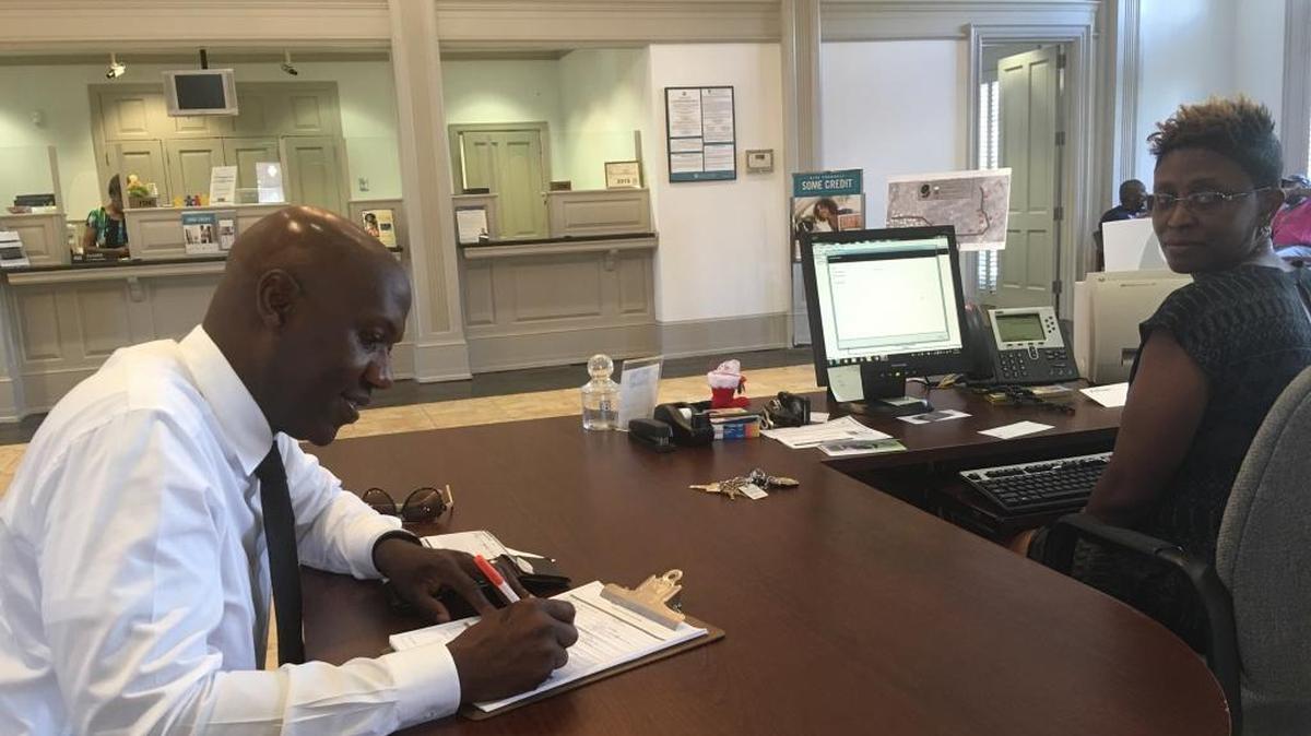 Micheal Muhammad, a member of the local organizing committee of the Justice or Else! Millions More March, opened a checking account at Citizens Trust Bank in the Midtown Shopping Center last month during “Black Dollars Day,” with the help of the bank’s Client Relationship Manager Tasha Toney.