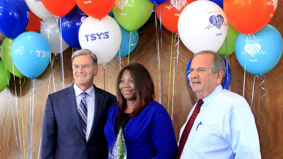 Troy Woods, left, and Phil Tomlinson, right, stand with Raveeta Addison after she is named the first recipient of the Phil Tomlinson Heart of TSYS Award Tuesday. Addison was nominated by seven different committee members for the inaugural award. She volunteers with Big Brothers Big Sisters of the Chattahoochee Valley, the Ronald McDonald House, United Way (including as a loaned executive and serving on the Allocation Panel for the 2015 campaign), the Columbus Dream Center, Girls, Inc., the Downtown Elementary Magnet Academy and is a member of Young Professionals. Woods is the TSYS president, chairman and CEO, and Tomlinson retired as CEO in July 2014 after 40 years with the company.