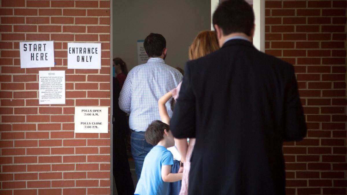 Residents line up to vote during the primary election on May 24, 2022, at St. Paul United Methodist in Columbus, Ga.