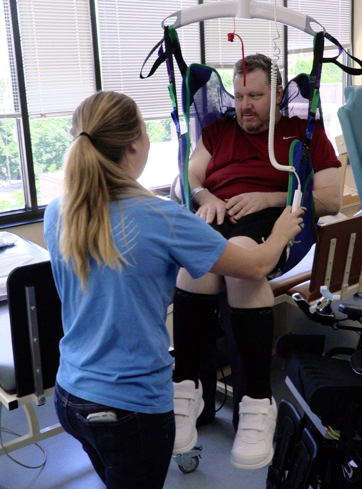 Occupational therapist Tayla Dockins moves Mark Jones back to his wheelchair after an occupational therapy session Tuesday at the Shepherd Center in Atlanta. Jones is at the Shepherd Center recovering from a spinal cord injury he sustained in an automobile accident.