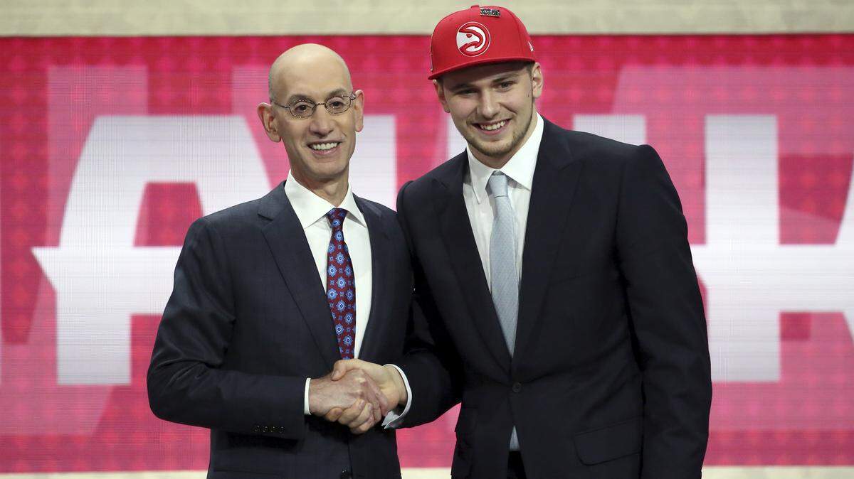 Luka Doncic poses for a picture with NBA commissioner Adam Silver after Doncic was picked third overall by the Atlanta Hawks during the NBA draft on Thursday. Doncic was traded to the Dallas Mavericks for point guard Trae Young later that night.