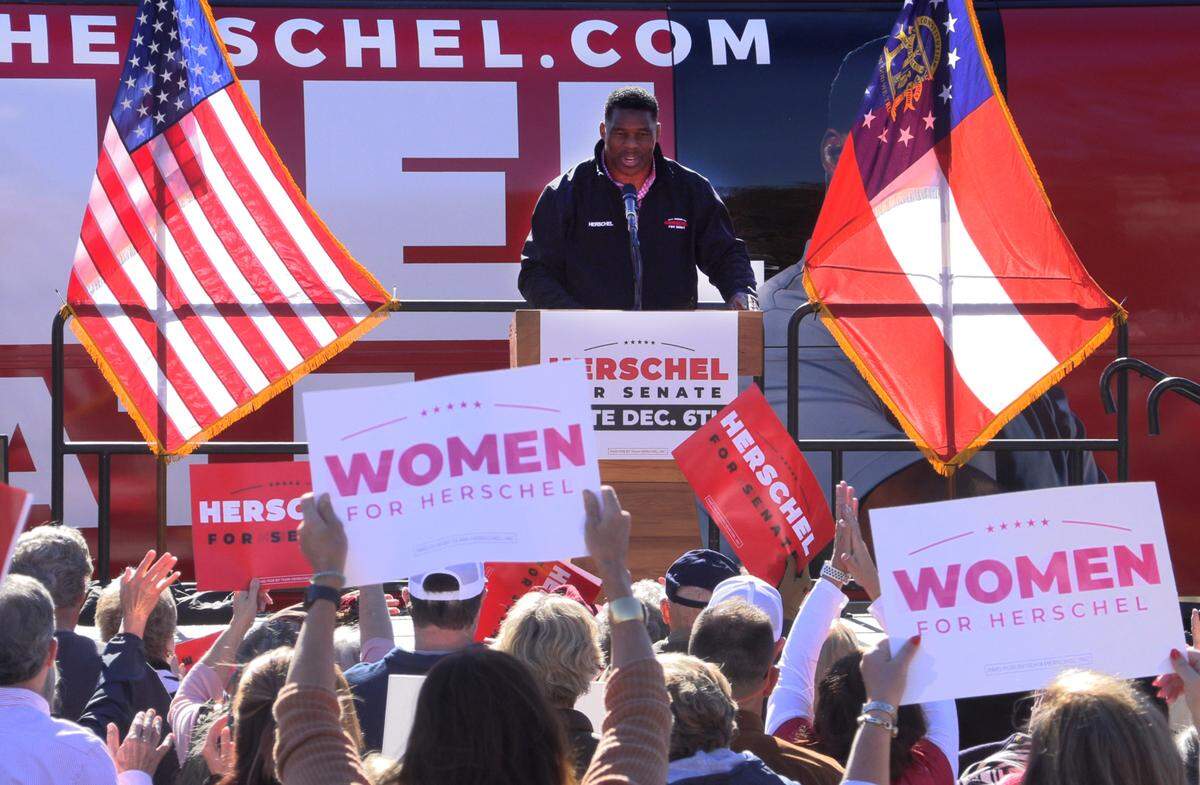 Herschel Walker, Republican candidate for U.S. Senate, campaigns Thursday at the Piggly Wiggly at 1359 13th Street in Columbus.