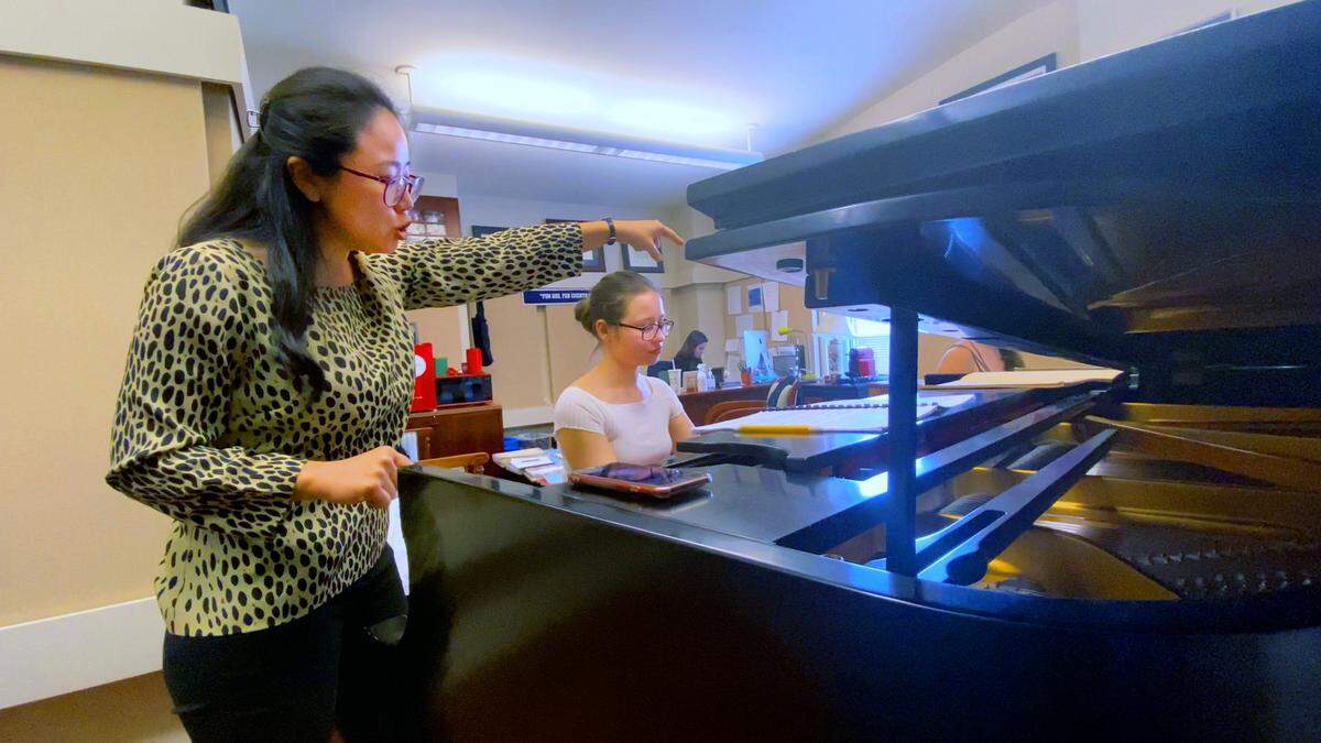 Anastasiia Zakharchenko, seated, a student at Columbus State University, plays as Esther Park, associate professor of piano at CSU’s Schwob School of Music, listens. 02/24/2023