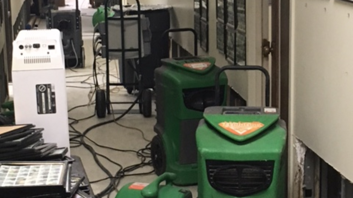 A worker is busy in a hallway at Columbus Government  Center Tower  after busted pipe flooded upper floors on June 18, 2018.